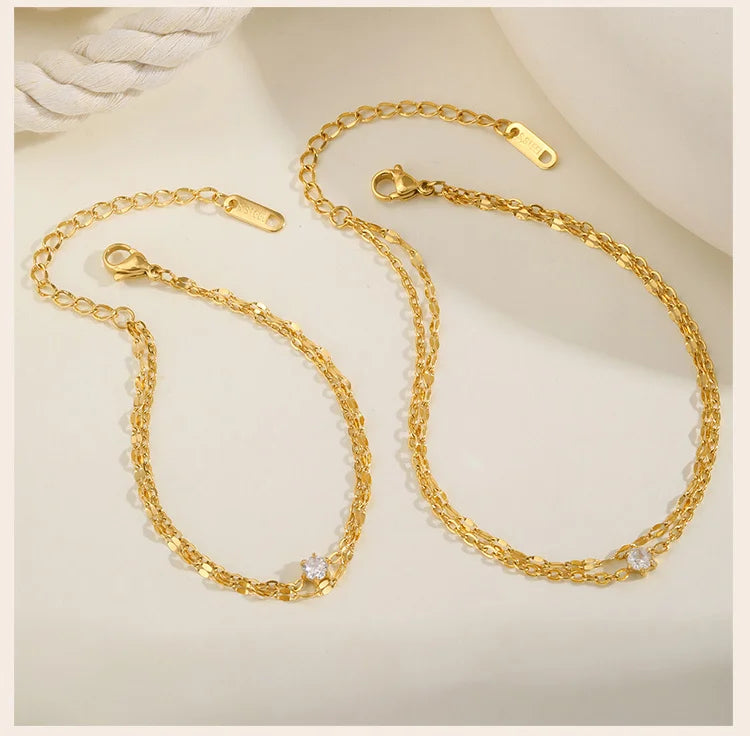 Bracelet de cheville superposé imperméable pour femmes, plaqué or réglable avec zircone, chaîne de pied à maillons en acier inoxydable, bijoux L’AURA