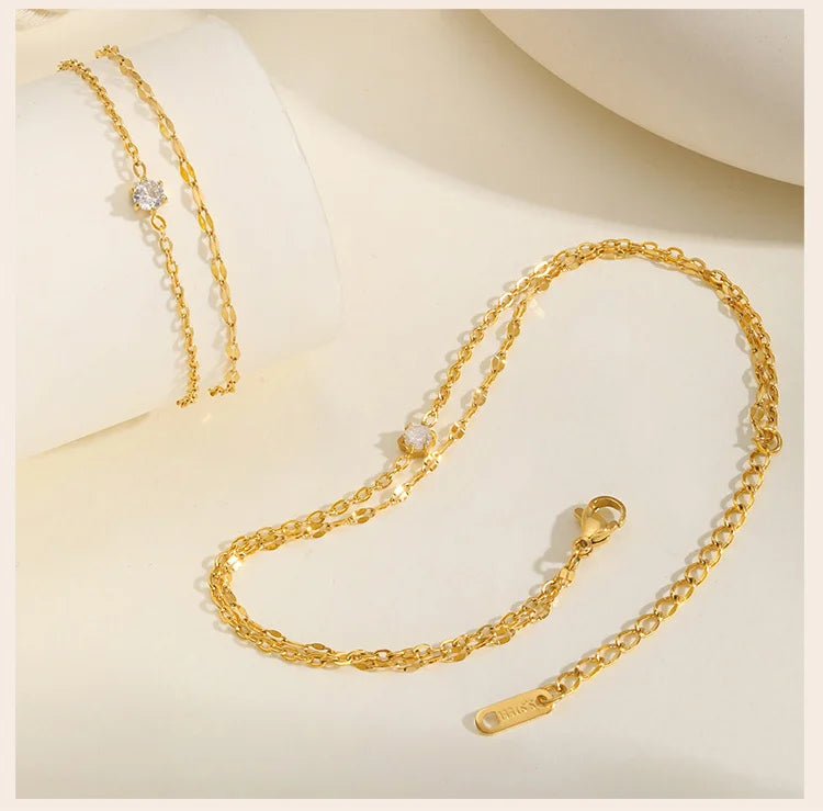 Bracelet de cheville superposé imperméable pour femmes, plaqué or réglable avec zircone, chaîne de pied à maillons en acier inoxydable, bijoux L’AURA