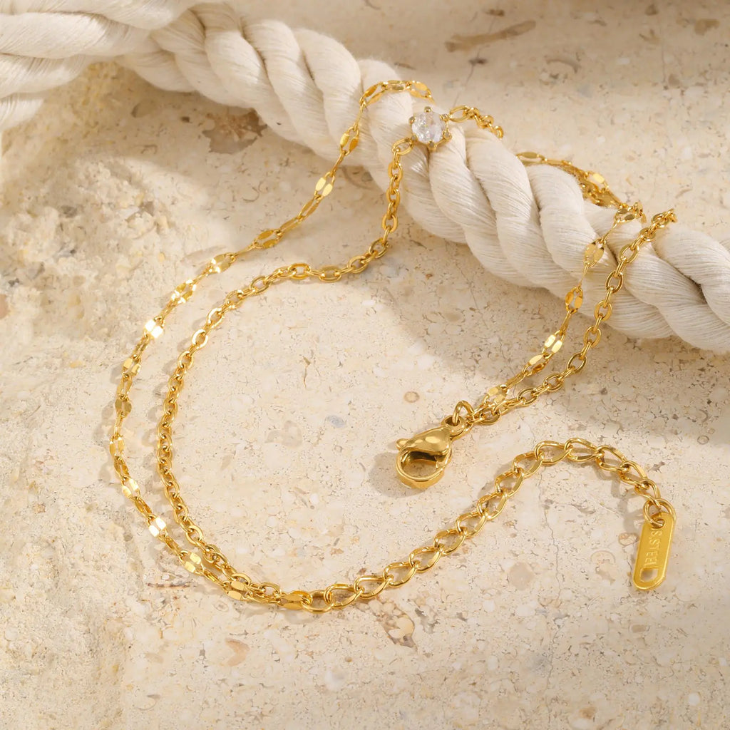 Bracelet de cheville superposé imperméable pour femmes, plaqué or réglable avec zircone, chaîne de pied à maillons en acier inoxydable, bijoux L’AURA